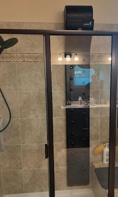 Bathroom shower and vanity area with updated lighting